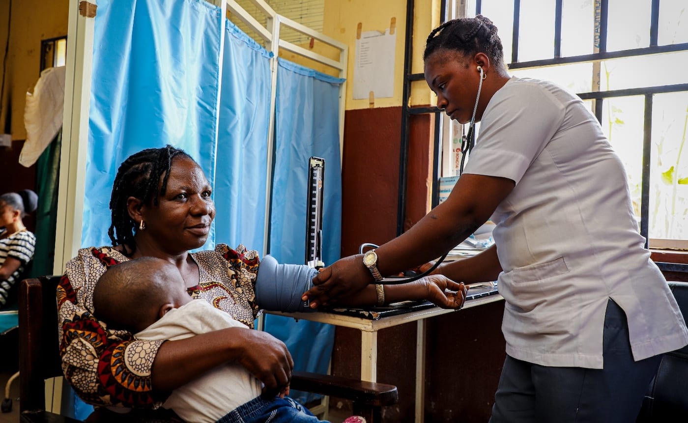 A clinician performing a routine check-up at an SFH clinic